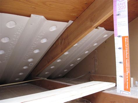installing insulation board in attic
